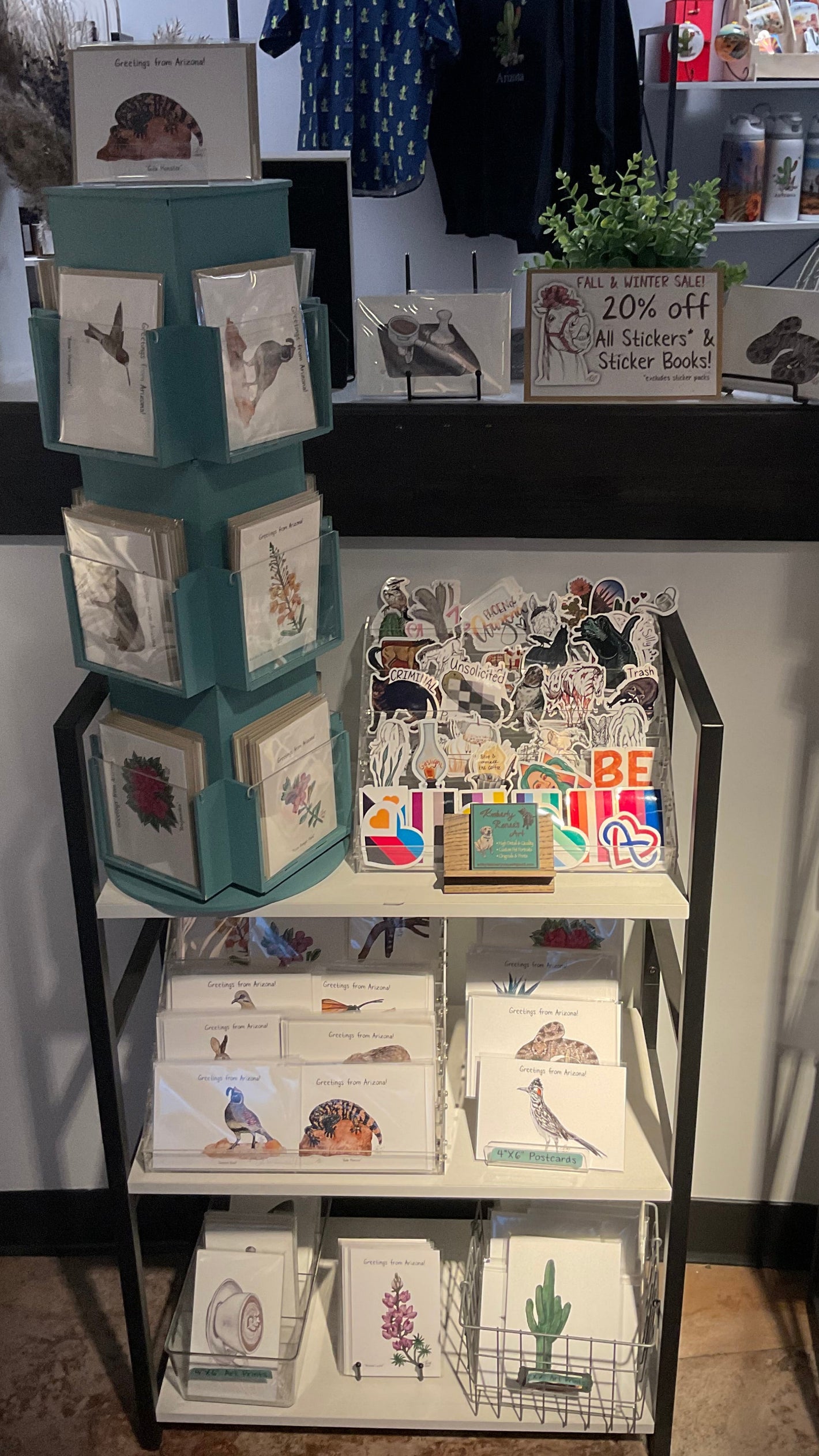 Display shelves with Kimberly Renee's Art greeting cards, prints, and stickers. Arizona, coffee, and animal themes.